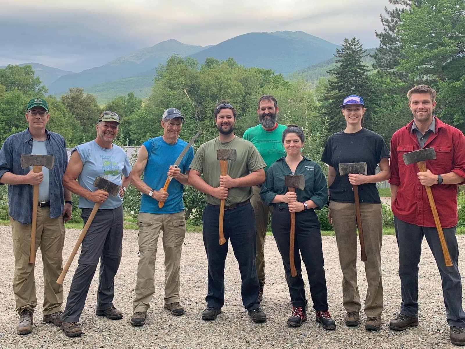 TCA alumni brandish their axes at Camp Dodge before a patrol with the 2024 Trail Crew. Left to right: Nate Lowrey, Tom Ross, Bob Biddle, Marshall Pontrelli, Willie Janeway, Annie Dumais, Lucy Milde, Alex Milde. 